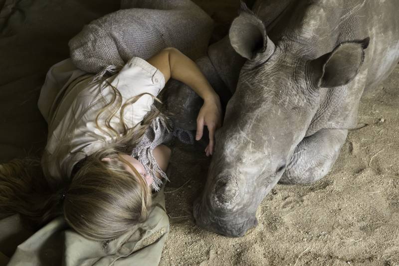 Jade sleeping with Chipoko the orphan rhino